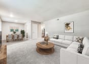 Thumbnail 2 of 20 - a living room with a white couch and a table