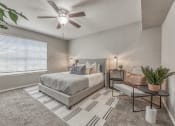 Thumbnail 11 of 20 - a bedroom with a bed and a ceiling fan