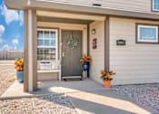 Thumbnail 3 of 21 - A house entrance with a wreath on the door and a sign that says "Welcome Home".