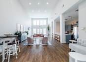 Thumbnail 8 of 29 - A modern living room with a white couch and a wooden floor.