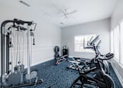 Thumbnail 17 of 29 - A spacious home gym with a variety of exercise equipment.