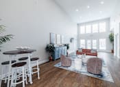 Thumbnail 9 of 29 - A living room with a white table and chairs.