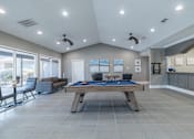 Thumbnail 32 of 62 - A room with a pool table and a couch.