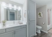 Thumbnail 11 of 62 - A bathroom with a white sink and a toilet.