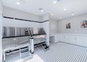 Thumbnail 43 of 62 - A clean, modern kitchen with a large stainless steel sink and white cabinets.