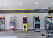 Thumbnail 37 of 62 - A row of arcade machines are lined up against a wall.
