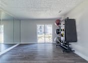 Thumbnail 41 of 62 - A room with a sliding glass door and a wooden floor.
