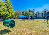 Thumbnail 60 of 62 - A playground with a green slide and a blue canopy.