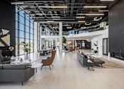 Thumbnail 1 of 35 - A modern open-plan office space with a mix of seating areas and natural light.