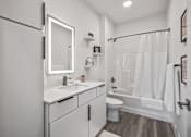 Thumbnail 34 of 35 - A white bathroom with a white toilet and a white sink.