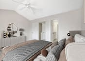 Thumbnail 20 of 33 - a bedroom with a large bed and a ceiling fan