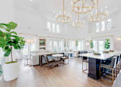 Thumbnail 10 of 33 - a dining room with white walls and a large table and chairs