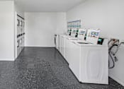 Thumbnail 16 of 23 - A laundromat with washers and dryers.