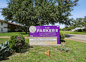 Thumbnail 23 of 23 - A sign for The Parker II Apartments is displayed in front of a building.