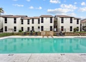 Thumbnail 14 of 22 - A swimming pool in front of a building with the number 411 on it.