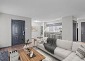Thumbnail 1 of 22 - A modern living room with a grey couch and a wooden coffee table.