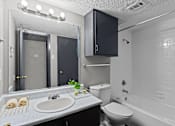 Thumbnail 6 of 22 - A bathroom with a sink, toilet, and bathtub.