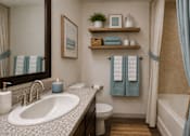 Thumbnail 4 of 44 - A bathroom with a white sink, a toilet, a bathtub, and a mirror.