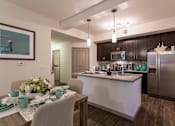 Thumbnail 4 of 40 - A modern kitchen with a dining table set for two.