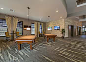 Thumbnail 19 of 40 - A room with a pool table and a television.