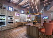 Thumbnail 18 of 40 - A modern kitchen with wooden cabinets and a large island.