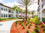 Thumbnail 37 of 40 - A red mulched garden in front of a white building.