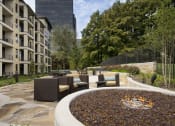 Thumbnail 11 of 23 - a fire pit in the middle of a courtyard with furniture