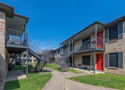 Thumbnail 17 of 19 - An exterior photo of a two-story apartment  building (Costa Mesa Apartments) with stairs