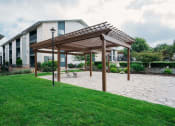 Thumbnail 19 of 27 - a patio with a pergola in front of a building