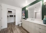 Thumbnail 19 of 66 - a bathroom with a large mirror and a sink and a toilet