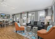 Thumbnail 9 of 19 - a living room with couches and chairs and a dining room table