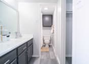Thumbnail 10 of 20 - a bathroom with a toilet and a sink and a mirror