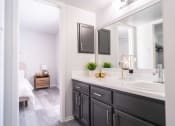 Thumbnail 11 of 20 - a bathroom with a sink and a mirror