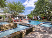 Thumbnail 12 of 20 - our apartments have a large pool with chairs and trees