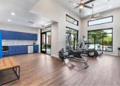 Thumbnail 14 of 20 - a gym with a reformer exercise bike and a window