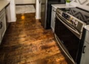 Thumbnail 7 of 39 - a small kitchen with a stove and a refrigerator