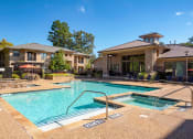 Thumbnail 29 of 32 - our apartments offer a swimming pool and a spa with a building in the background