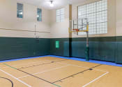 Thumbnail 24 of 36 - a basketball court in a gym with a basketball hoop