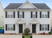 Thumbnail 16 of 36 - a white house with black shutters and a sidewalk