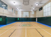 Thumbnail 25 of 36 - a basketball court in a gym at a community center