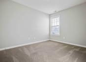 Thumbnail 33 of 36 - the spacious living room with carpeting and a window