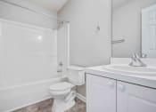 Thumbnail 28 of 36 - a white bathroom with a sink and a toilet