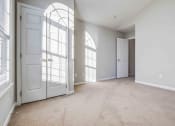 Thumbnail 27 of 36 - an empty living room with white doors and white walls