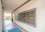 Thumbnail 10 of 35 - A long hallway with a mailbox on the wall.