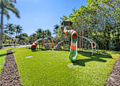 Thumbnail 35 of 40 - A playground with a green slide and a red and white slide.