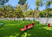Thumbnail 36 of 40 - A red bench sits in a green park.