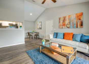 Thumbnail 1 of 19 - a living room with a couch and a coffee table