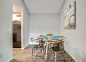Thumbnail 5 of 19 - a dining room with a table and chairs