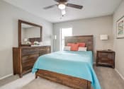 Thumbnail 6 of 19 - a bedroom with a bed and a ceiling fan