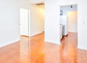 Thumbnail 5 of 13 - A room with a white door and a white refrigerator.
